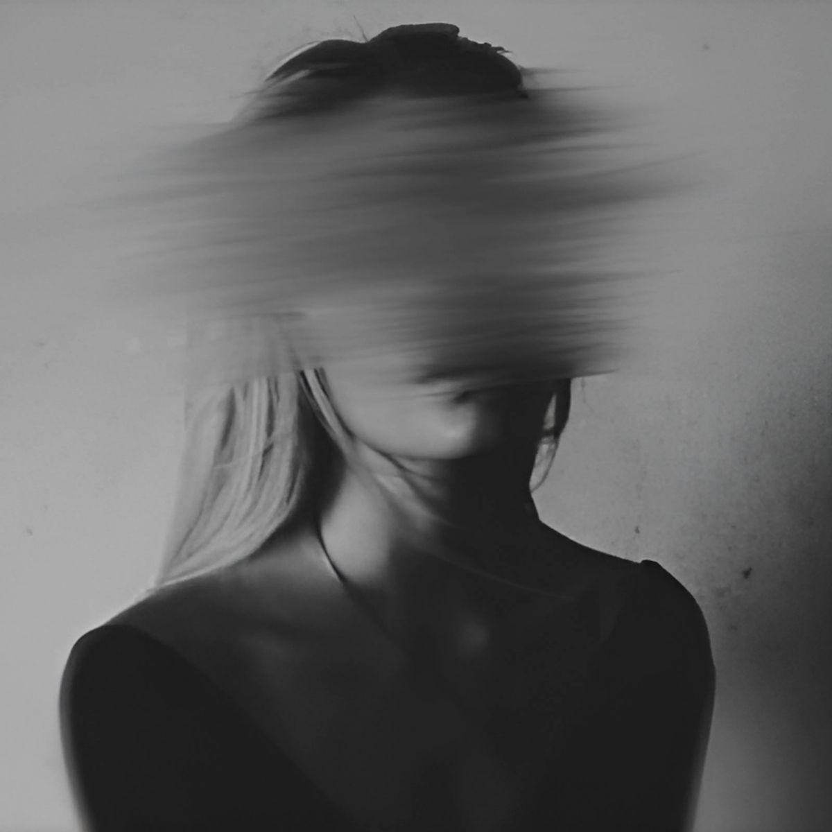Black and white photo of a woman with the face smeared and smuged to be blurred. This is the author photo for Roxy Wright